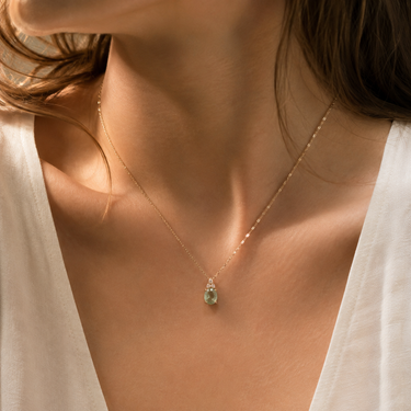 Pendant necklace with soft ivory fabric in warm natural light