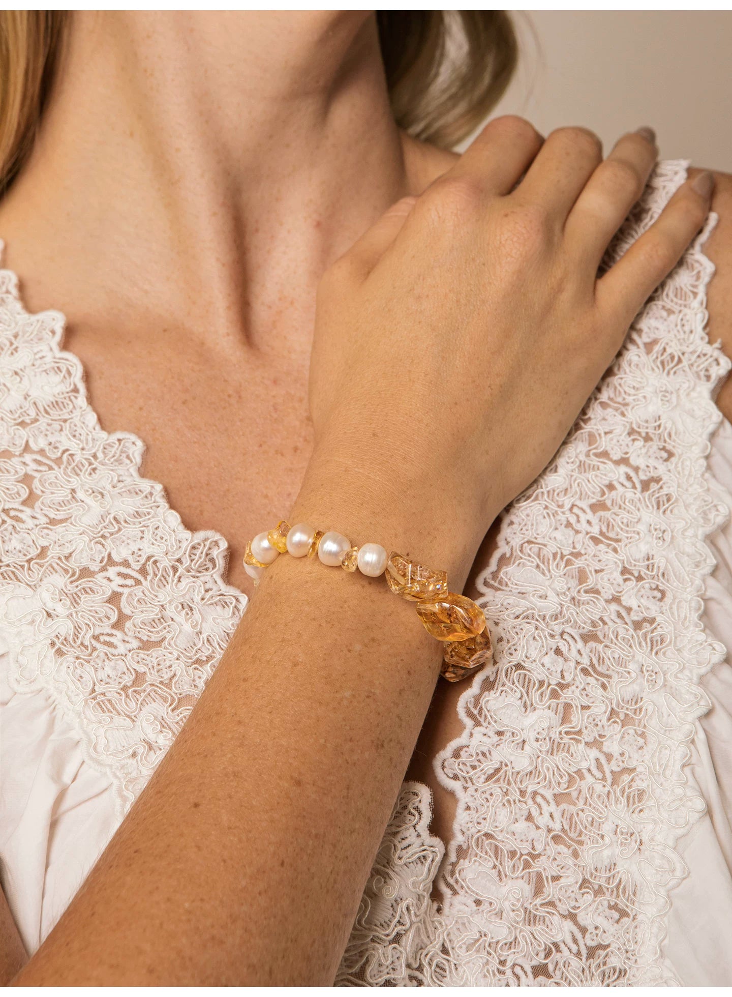 Close-up of the Golden Halo citrine and freshwater pearl bracelet on the wrist