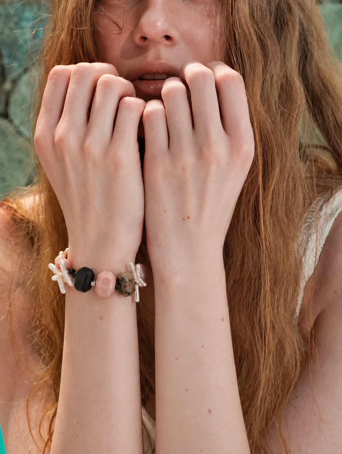 Model wearing the LUMERUNE Blush Eclipse pink opal, black onyx and baroque pearl bracelet