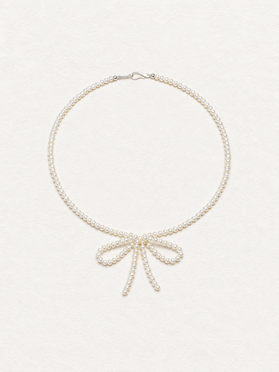 LUMERUNE Muse Pearl Bow Necklace — seed pearls forming a delicate bow