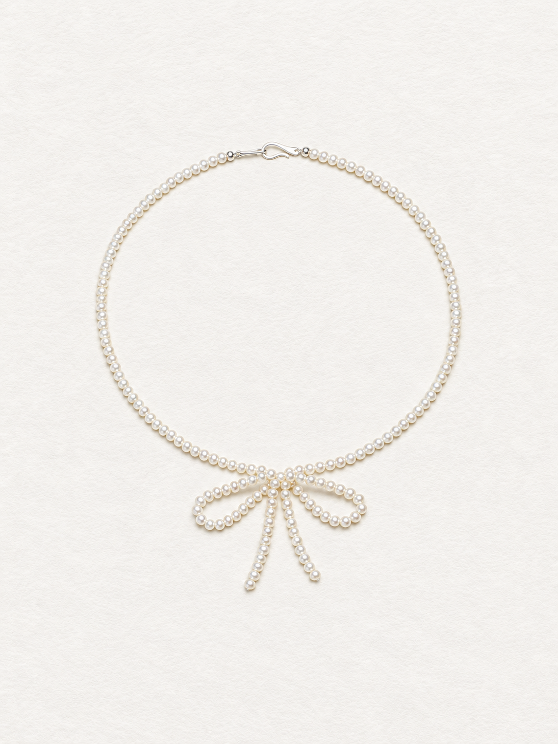 LUMERUNE Muse Pearl Bow Necklace — seed pearls forming a delicate bow