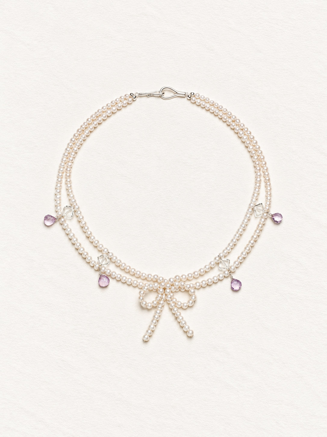 LUMERUNE Muse Pearl Bow Necklace With Amethyst — seed pearls, clear crystal, amethyst drops and a pearl bow