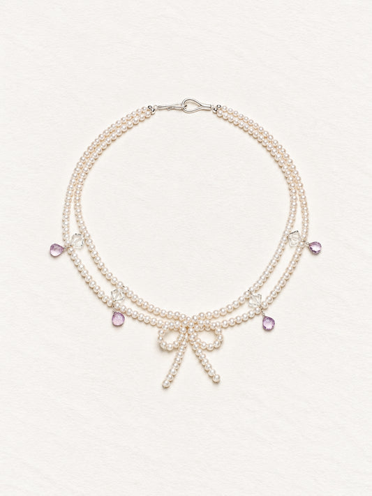 LUMERUNE Muse Pearl Bow Necklace With Amethyst — seed pearls, clear crystal, amethyst drops and a pearl bow
