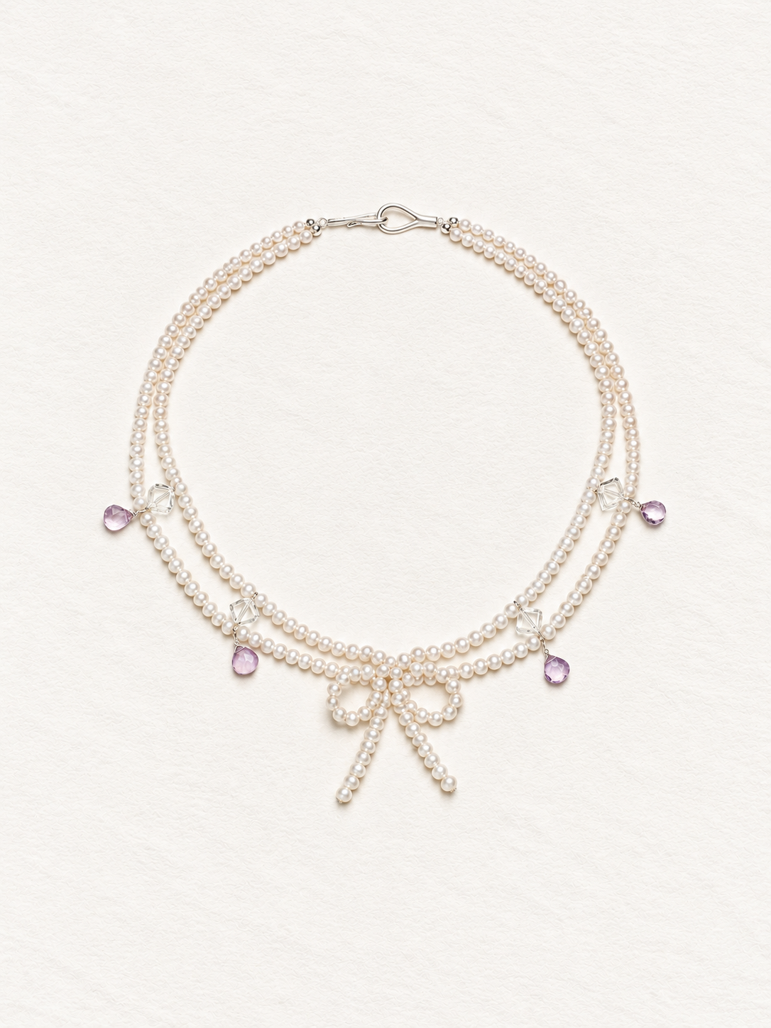 LUMERUNE Muse Pearl Bow Necklace With Amethyst — seed pearls, clear crystal, amethyst drops and a pearl bow