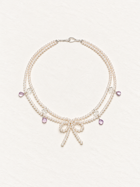LUMERUNE Muse Pearl Bow Necklace With Amethyst — seed pearls, clear crystal, amethyst drops and a pearl bow