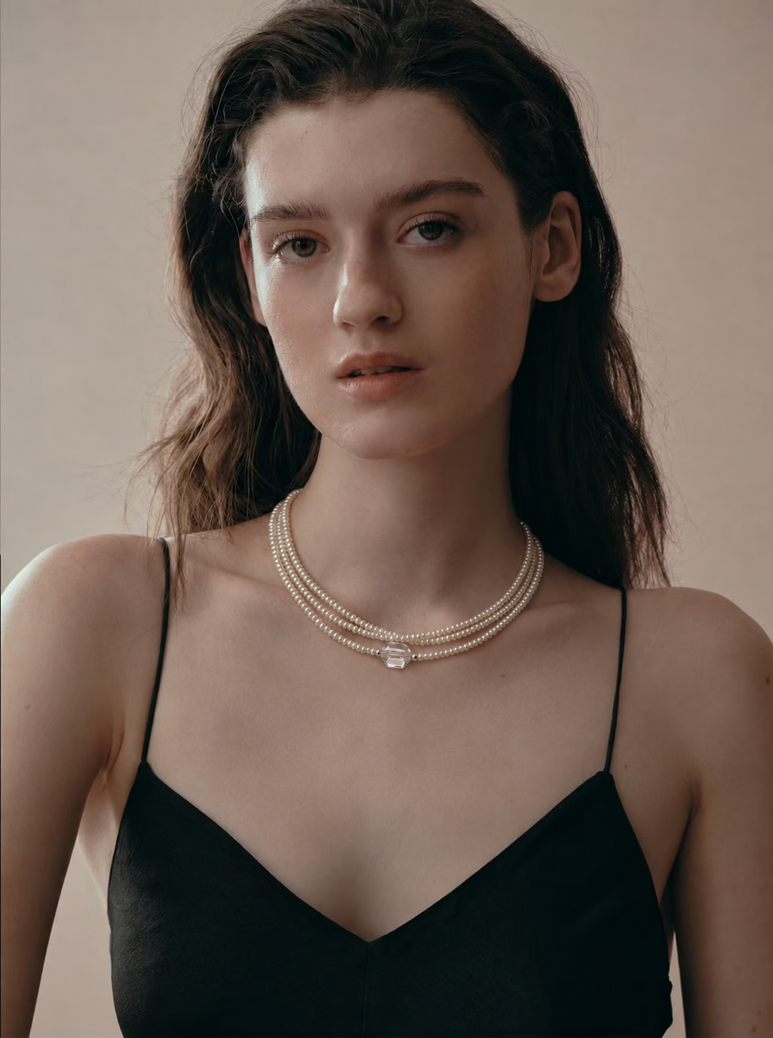 Model wearing the LUMERUNE Moonlit Thread pearl and clear quartz necklace