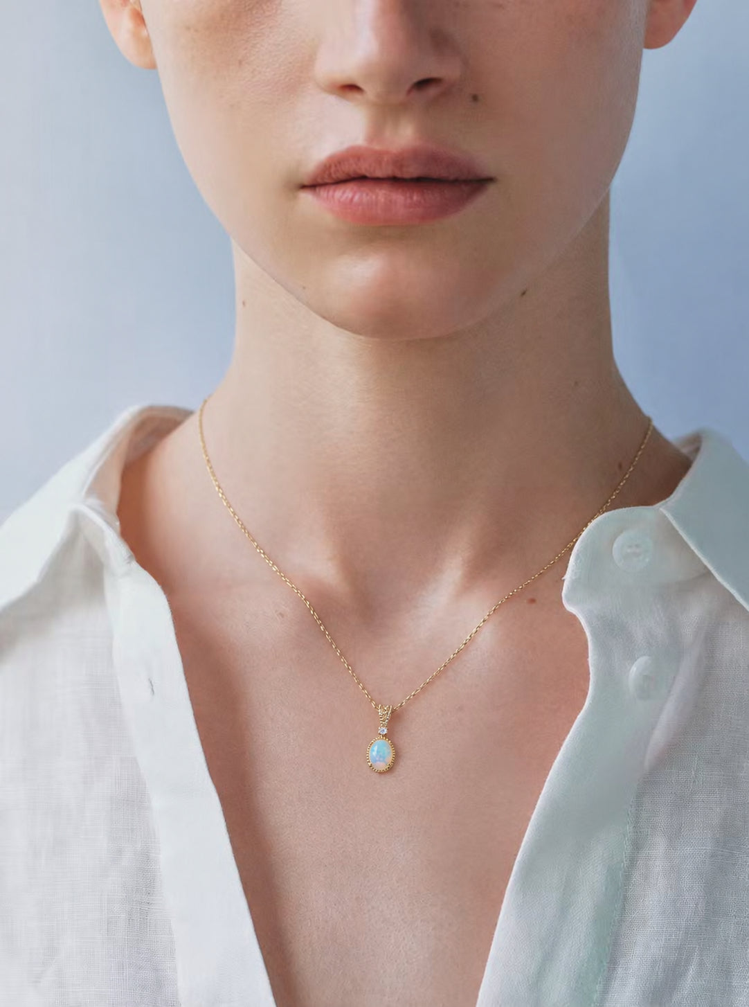 LUMERUNE Lunar Opal Starlight Pendant — oval opal in a gold toned setting with a white zircon