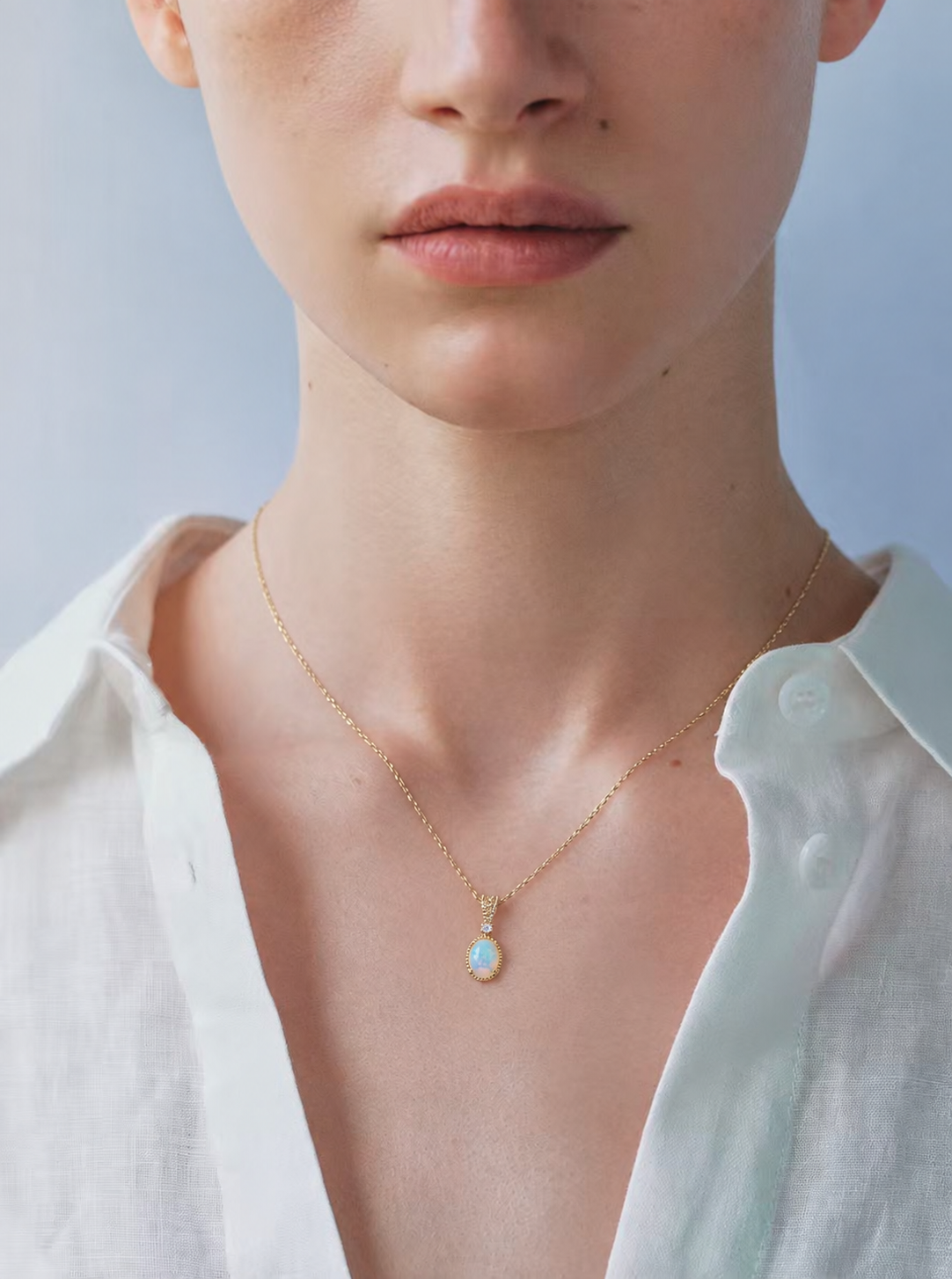 LUMERUNE Lunar Opal Starlight Pendant — oval opal in a gold toned setting with a white zircon